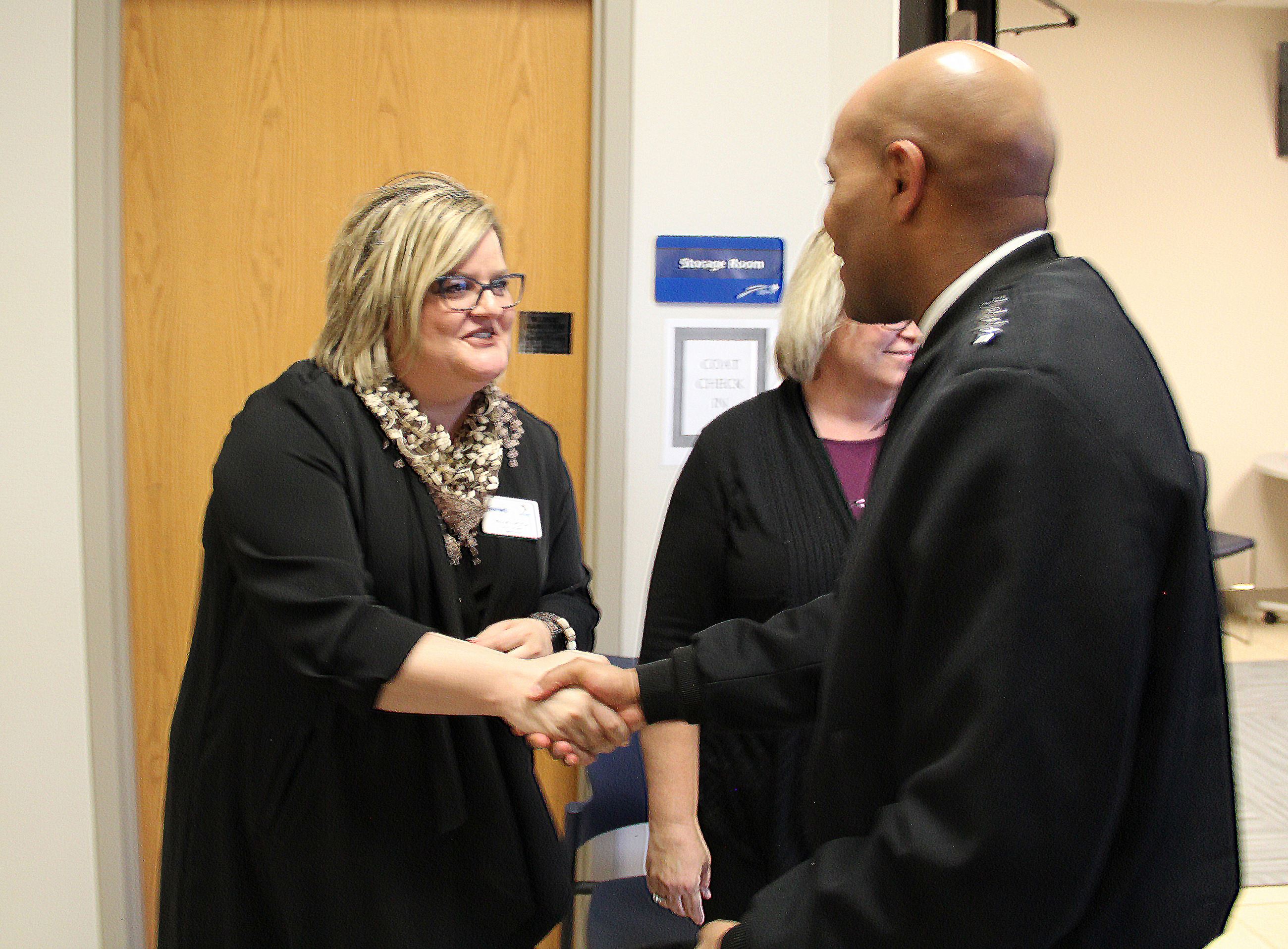 Renae Moch Greeting Jerome Adams.JPG