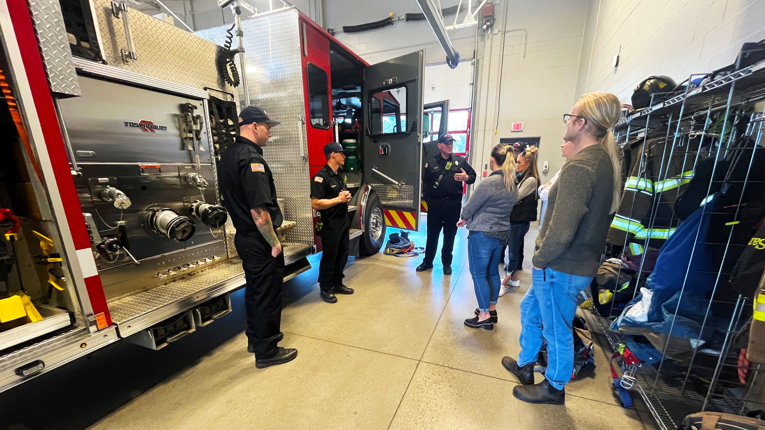 Firefighters show Citizen Academy attendees what types of equipment are carried on fire engines. 