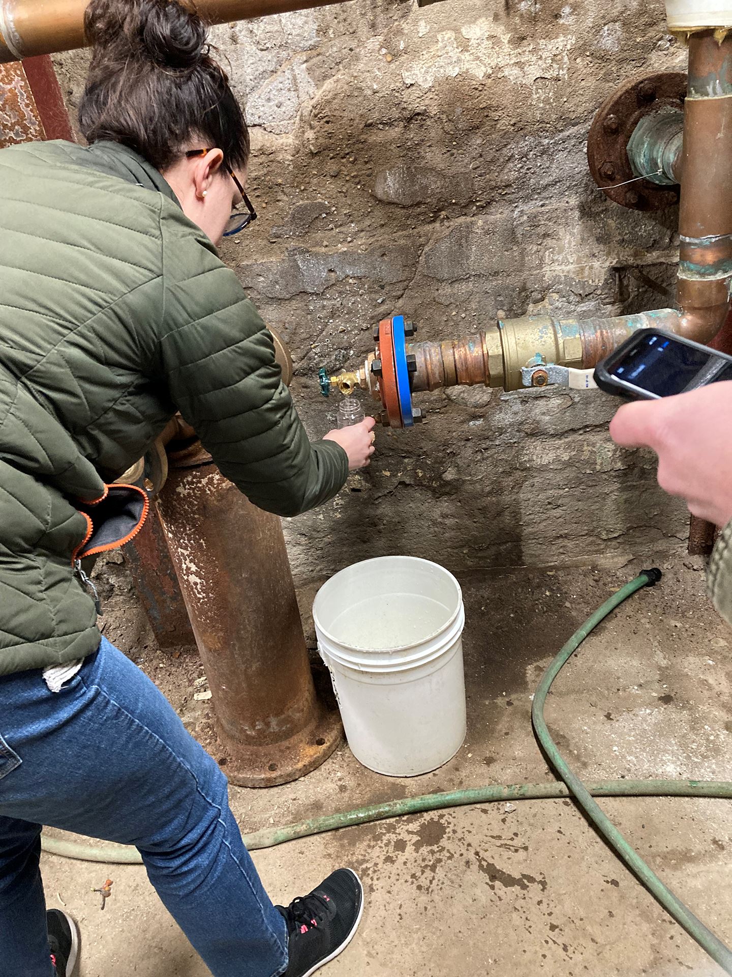 Bismarck firefighters attach a hose to a hydrant to help scour the affected water system.