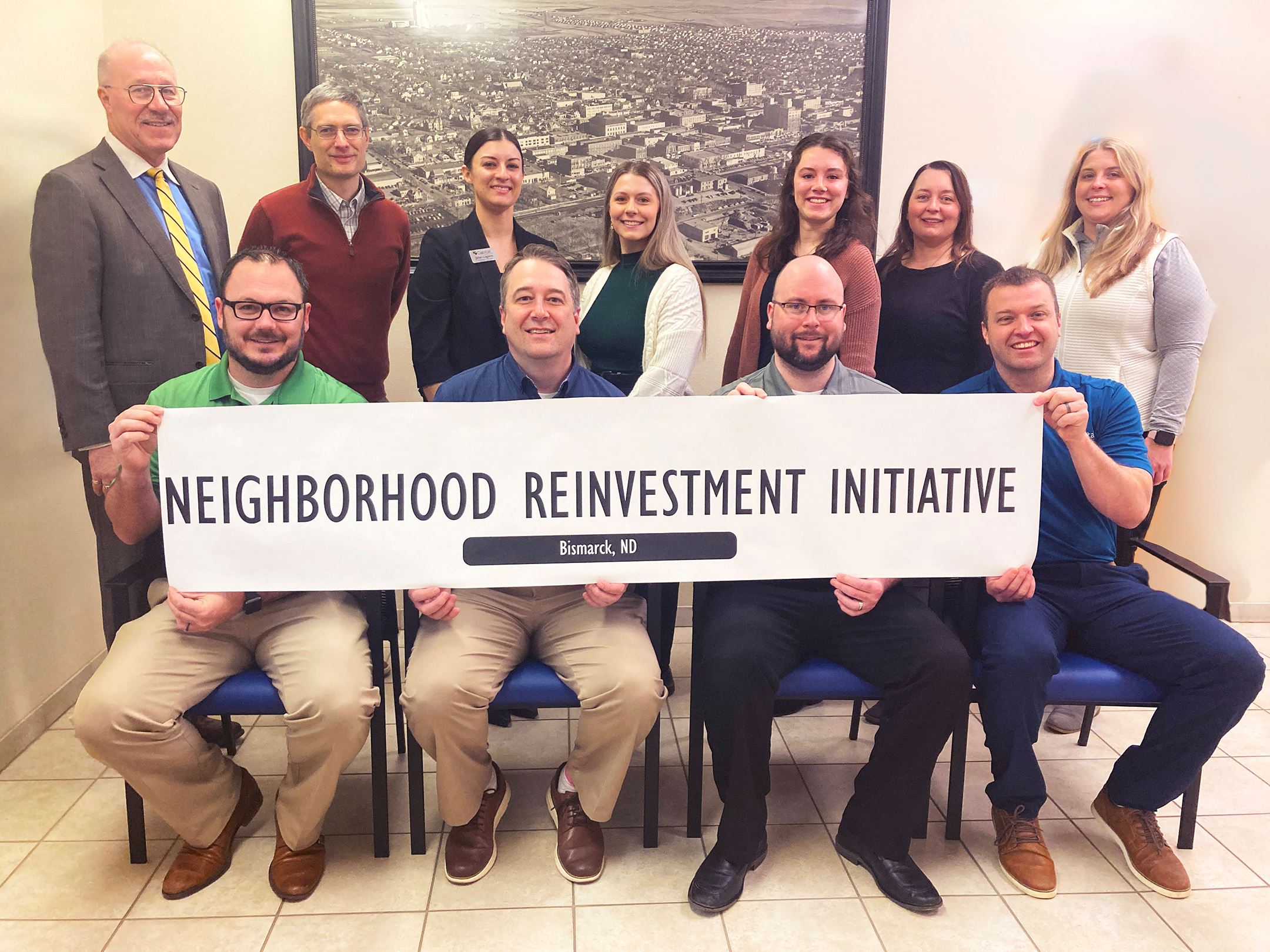 Members of an area bank met with City leaders to celebrate a new Neighborhood Reinvestment program.
