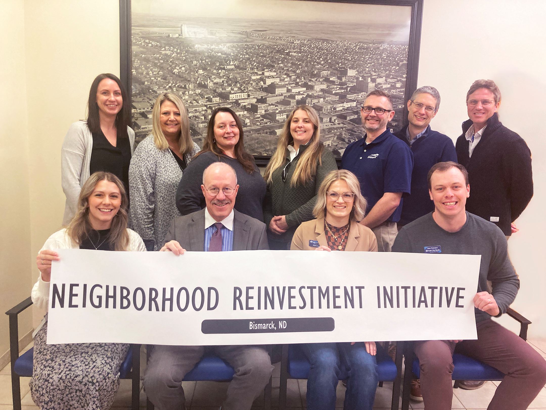 Members of an area bank met with City leaders to celebrate a new Neighborhood Reinvestment program.